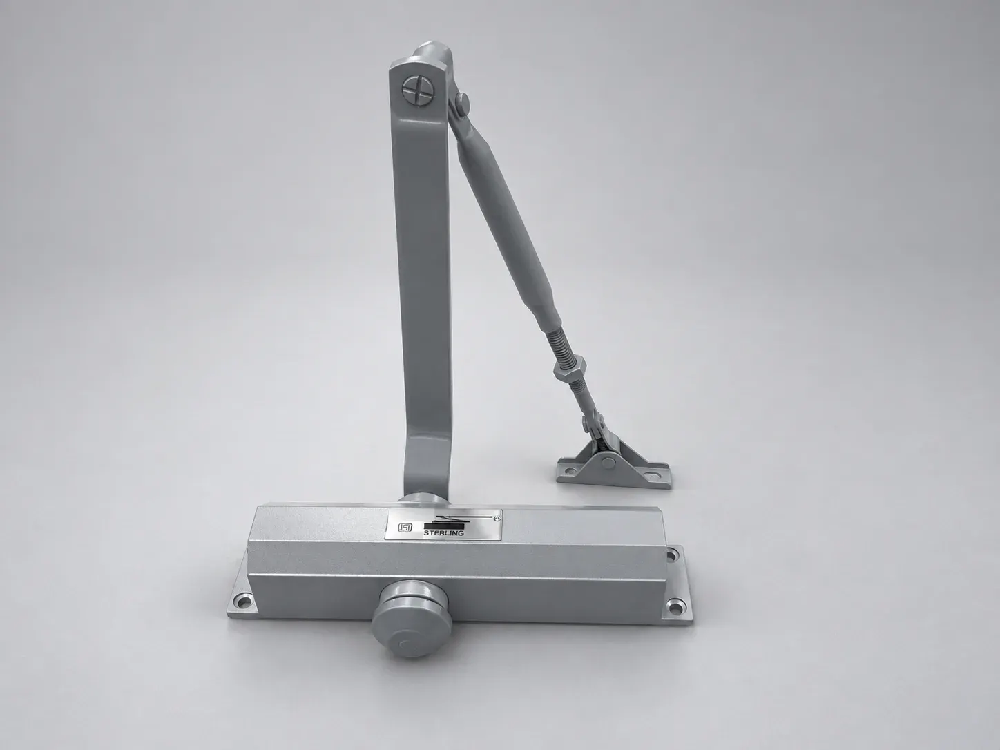 Sterling DC 1500 door closer with its lever arm raised, front view from slightly above, studio photograph