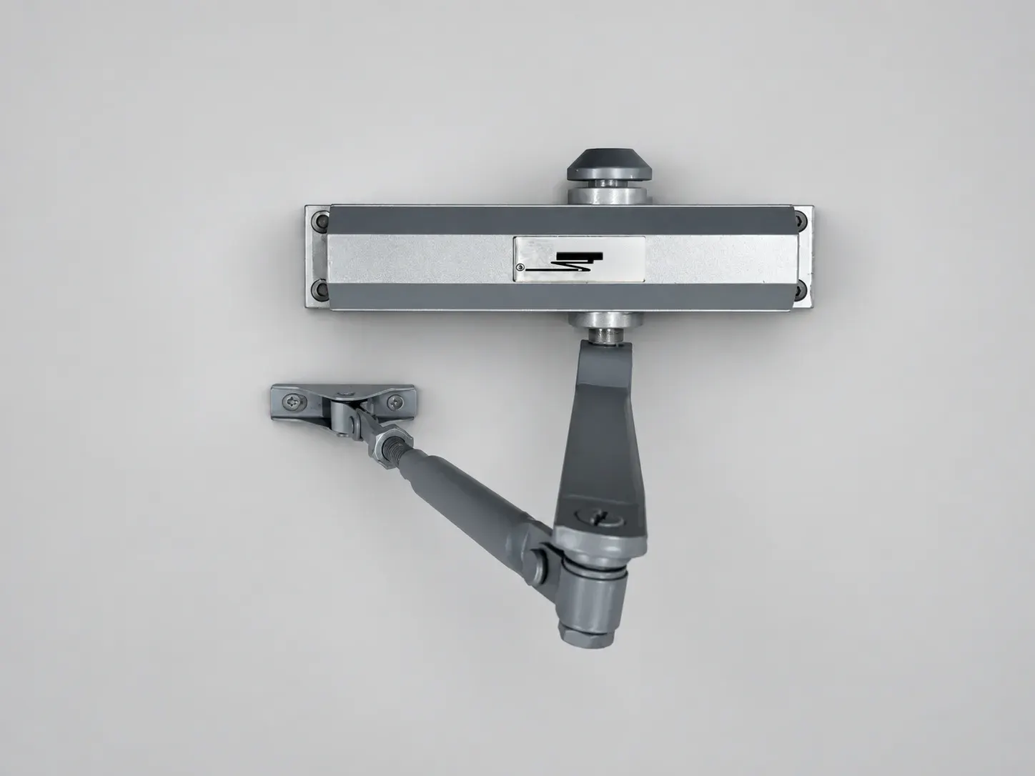 Sterling DC 1500 door closer with its lever arm and bracket, seen from above, studio photograph
