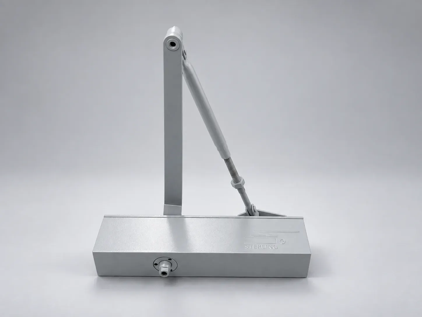 Sterling DC 2000 door closer body with lever arm, silver, front view, studio photograph