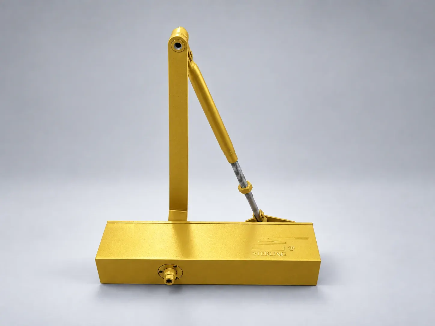 Sterling DC 2000 door closer with its lever arm raised, front view, digitally recoloured studio photograph showing the gold finish